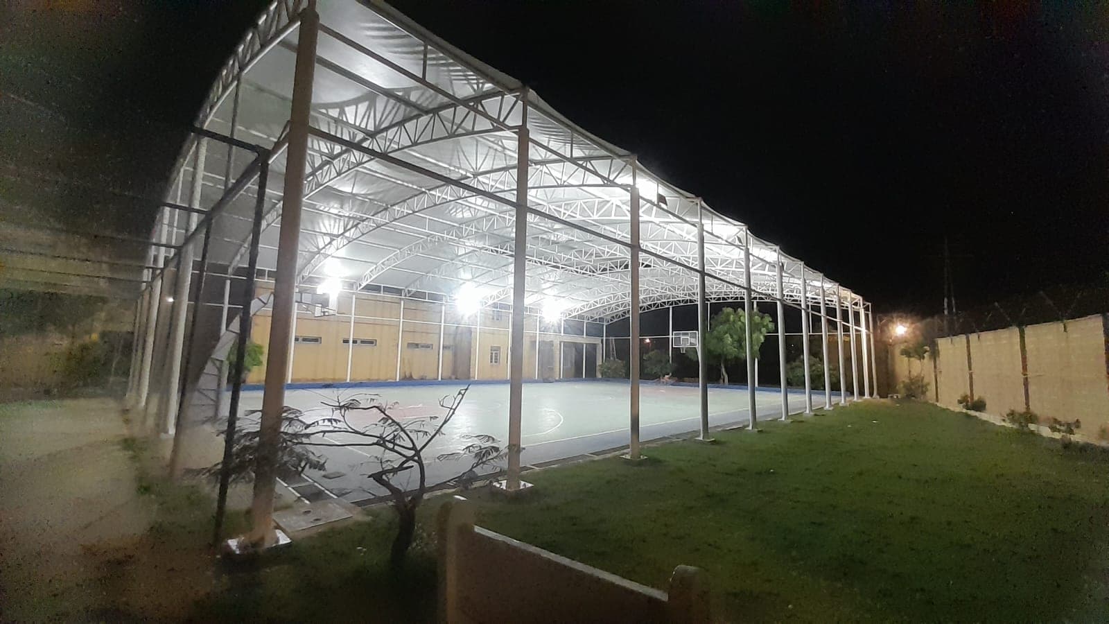 Night perspective of covered sports ground canopy structure at Karachi Grammar School