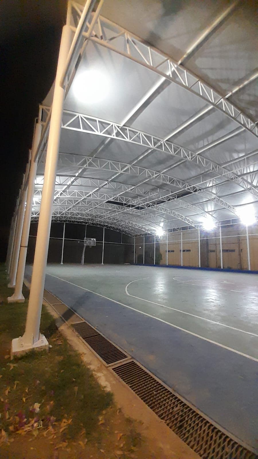 Floodlit covered basketball court canopy structure at Karachi Grammar School Saddar campus