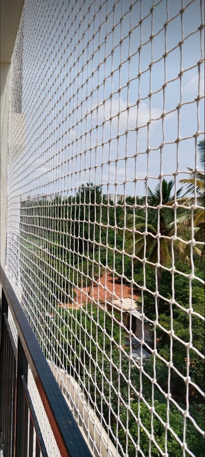High-rise balcony safety and bird protection mesh installed on outdoor railing