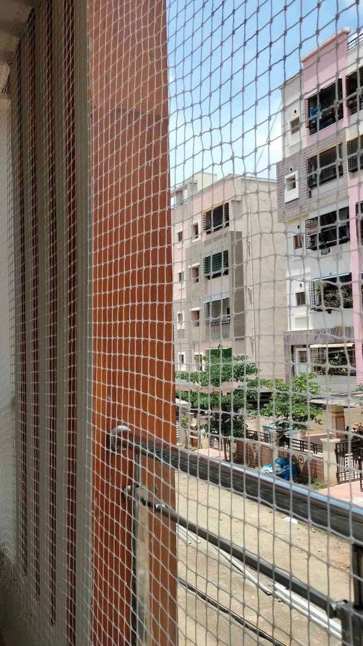 Balcony safety net installation on stainless steel railing Karachi
