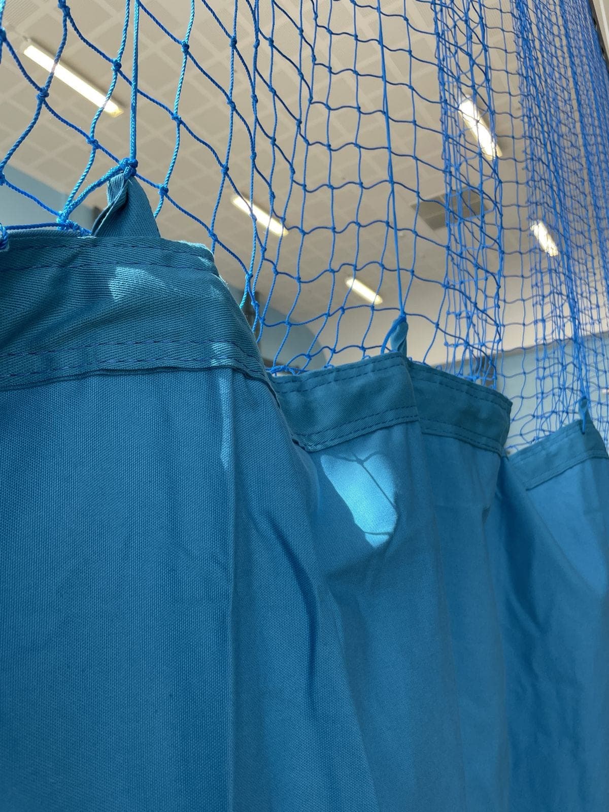 Blue indoor gymnasium divider curtain net with canvas skirt