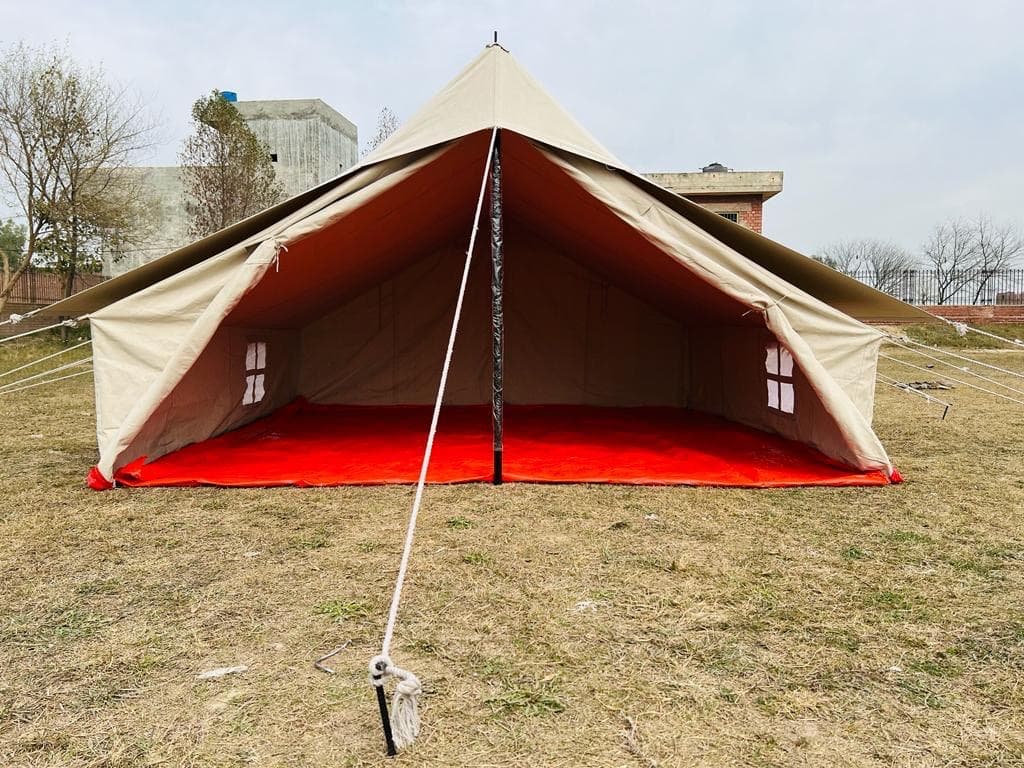 Heavy-duty A-frame canvas emergency relief tent pitched with guy ropes in Pakistan - Tahira Syndicate