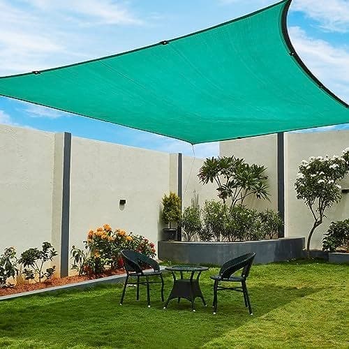 Green shade net canopy installed over garden patio and lawn Karachi